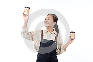 Cheerful young asian woman barista in casual work attire happily holding a takeaway coffee cup, isolated white background.
