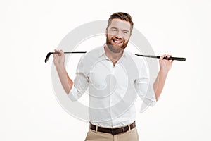 Cheerful young bearded man holding golfstick