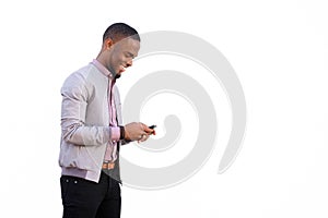 Cheerful young black guy sending text message