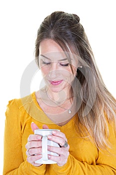 Cheerful young bonde caucasian woman looking mug hot drink photo