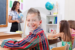 Cheerful young boy in school