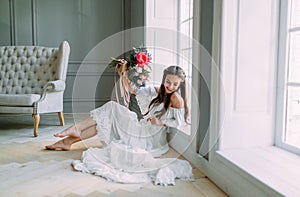 Cheerful, young bride holds a rustic wedding bouquet with peonies on panoramic window background. Close-up portrait. A