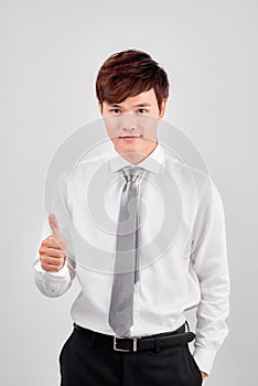 Cheerful young business man in classic white shirt tie posing isolated on white background studio portrait