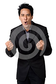 A cheerful young business man with clenched fist isolated