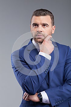 Cheerful young business worker is thinking