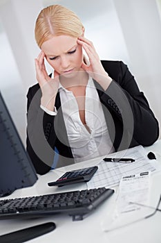 Cheerful young businesswoman with headache