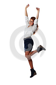 Cheerful young businesswoman jumping with arms up