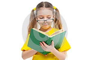 Cheerful young child girl with glasses holding a book to study isolated on a white background.