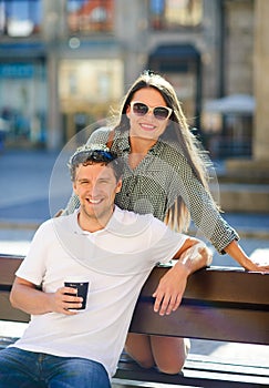 Cheerful young couple on a bench.