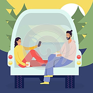 Cheerful young couple enjoy vacation sitting in rear of van, people in camper van, picnic in the forest