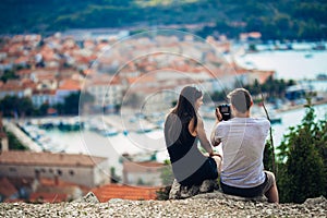 Cheerful young couple having a field trip date.Cityscape sightseeing,seaside travel vacation.Traveling in Europe