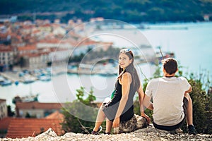 Cheerful young couple having a field trip date.Cityscape sightseeing,seaside travel vacation.Traveling in Europe