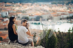 Cheerful young couple having a field trip date.Cityscape sightseeing,seaside travel vacation.Traveling in Europe photo