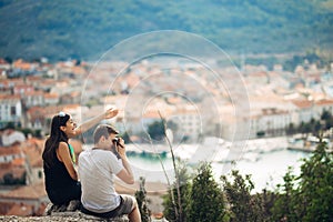 Cheerful young couple having a field trip date.Cityscape sightseeing,seaside travel vacation.Traveling in Europe photo