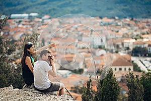 Cheerful young couple having a field trip date.Cityscape sightseeing,seaside travel vacation.Traveling in Europe photo