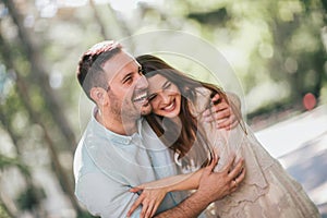 Cheerful young couple having fun and laughing together