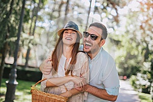 Cheerful young couple having fun and laughing together outdoors