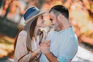 Cheerful young couple having fun and laughing together outdoors