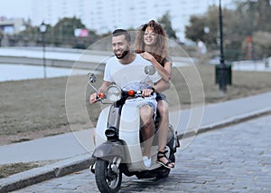 Happy cheerful couple riding vintage scooter. Travel concept.