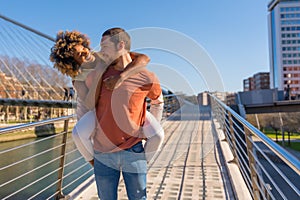 Cheerful young couple in vibrant outfits enjoying some quality time together outdoors in urban area