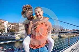 Cheerful young couple in vibrant outfits enjoying some quality time together outdoors in urban area