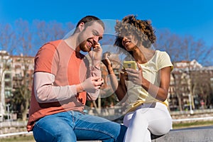 Cheerful young couple in vibrant outfits enjoying some quality time together outdoors in urban area