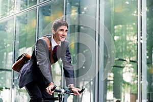 Cheerful young employee riding an utility bicycle in Berlin