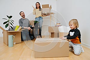 Cheerful young family exited about moving into a new home