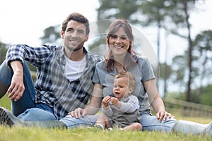 cheerful young family spending time together at farm