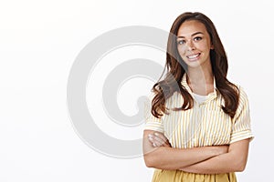 Cheerful young female cross arms confident pose, smiling joyfully, gladly answer customer question as standing over