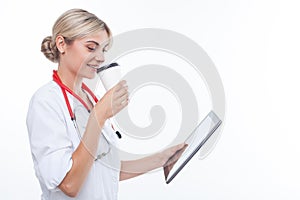 Cheerful young female doctor is resting on break