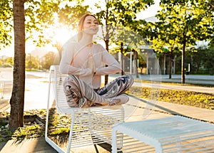 Cheerful young fitness woman relaxing outdoos