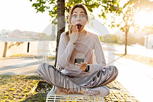 Cheerful young fitness woman relaxing outdoos