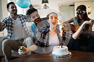 Cheerful young friends having fun on party