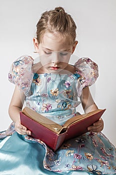 Cheerful Little Girl Engrossed in Reading, Embracing Knowledge and Education photo