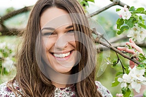 Cheerful young girl enjoying springtime outside in nature