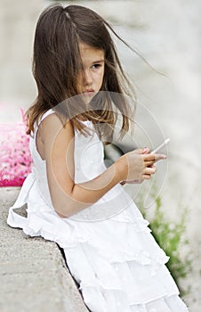 Cheerful young girl in white dress