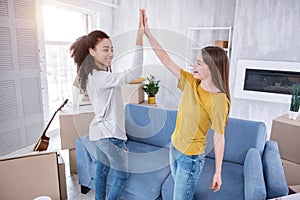 Cheerful young girls giving each other high five photo