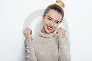 Cheerful young good looking woman with adorable smile hair bun posing on white isolated background. smiling broadly photo