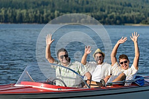 Cheerful young guys partying in speed boat photo