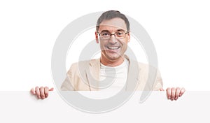 Cheerful young handsome man with blank signboard