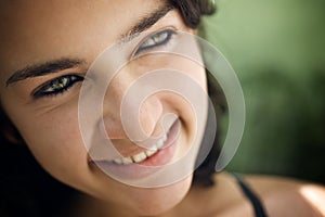 Cheerful young hispanic woman looking at camera and smiling