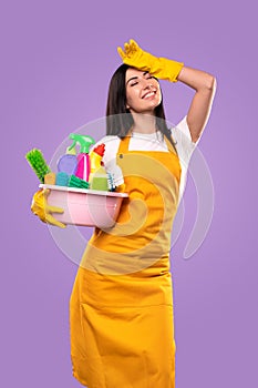 Cheerful young housewife wiping forehead