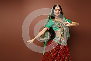 cheerful young indian woman in green