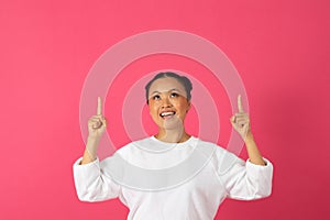 Cheerful Young Korean Female Pointing Upwards At Copy Space Above Her Head