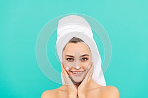 cheerful young lady applying face cream on blue background