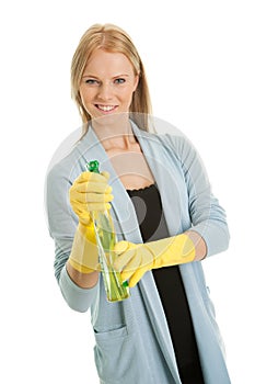 Cheerful young lady spraying cleaner liquid