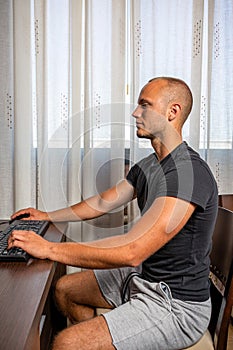 Cheerful young male student enjoying training webinar on laptop computer preparing coursework plan,happy skilled freelancer browse