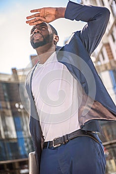 Cheerful young male worker waiting in city