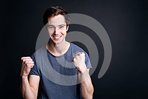 Cheerful young man expressing jubilation